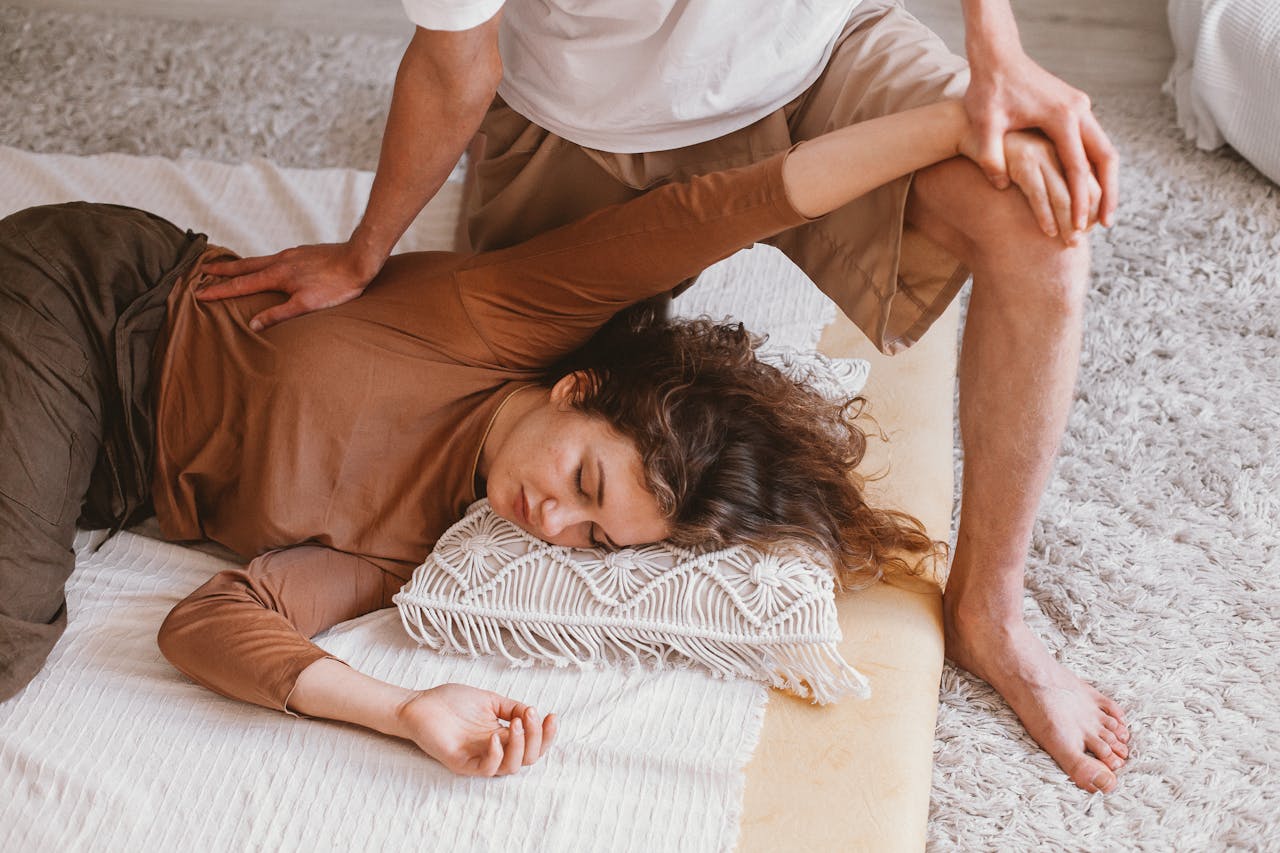 Relaxing indoor massage session capturing warmth and comfort with a focus on therapeutic techniques.